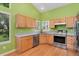Modern kitchen with stainless steel appliances, stone countertops, and bright wooden cabinets at 1241 S Akron Way, Denver, CO 80247