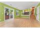 Open living area featuring hardwood floors and sliding glass doors that lead to a balcony at 1241 S Akron Way, Denver, CO 80247