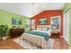 Bright primary bedroom features large windows, a vaulted ceiling, and a modern chandelier at 1241 S Akron Way, Denver, CO 80247