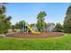 Community playground with slide and climbing structure on a cushioned mulch surface at 1241 S Akron Way, Denver, CO 80247