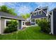 Spacious backyard featuring a well-maintained lawn, patio with dining, shed, and house exterior at 5675 S Crocker St, Littleton, CO 80120