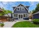 Beautiful backyard with lush green lawn, patio with dining set, and a charming two-story home exterior at 5675 S Crocker St, Littleton, CO 80120