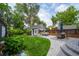 Landscaped backyard featuring a lush lawn, patio area with an outdoor dining set, and a small storage shed at 5675 S Crocker St, Littleton, CO 80120