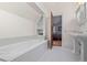 Elegant bathroom with a built-in tub and a view of a bedroom, exuding luxury at 5675 S Crocker St, Littleton, CO 80120
