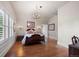 Elegant bedroom features hardwood floors, shuttered windows, and a stylish chandelier for a luxurious ambiance at 5675 S Crocker St, Littleton, CO 80120
