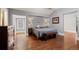 Cozy bedroom with hardwood floors, complemented by sconce lighting and blue bedding for a serene atmosphere at 5675 S Crocker St, Littleton, CO 80120