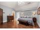 Bright bedroom with hardwood floors, a ceiling fan, and sconce lighting, creating a calm and inviting space at 5675 S Crocker St, Littleton, CO 80120