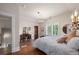 Bright bedroom features hardwood floors, white walls, and a vanity at 5675 S Crocker St, Littleton, CO 80120
