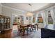 Bright dining room with hardwood floors, modern chandelier, and views into living room at 5675 S Crocker St, Littleton, CO 80120