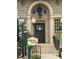 Classic brick building with an arched entryway, adorned with an elegant hanging lantern and decorative architectural details at 5675 S Crocker St, Littleton, CO 80120
