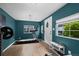 Home gym featuring blue painted walls, laminated wood flooring, a treadmill and weightlifting equipment at 5675 S Crocker St, Littleton, CO 80120