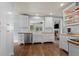 Bright kitchen boasts white cabinets, stainless steel appliances, wood countertops, and a farmhouse sink at 5675 S Crocker St, Littleton, CO 80120