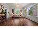 Spacious living room featuring hardwood floors, bright windows with white shutters, and a stylish light fixture at 5675 S Crocker St, Littleton, CO 80120