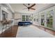 Sunroom/living room with many windows, hardwood floors, and adjacent bar at 5675 S Crocker St, Littleton, CO 80120