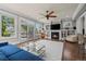 Spacious living room with fireplace, built-in shelving, lots of natural light, and hardwood floors at 5675 S Crocker St, Littleton, CO 80120
