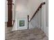 Staircase with hardwood floors, white banister, and stained glass window at 5675 S Crocker St, Littleton, CO 80120