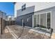 View of the backyard and the back of the house with a sliding glass door at 10863 E Hinsdale Cir, Centennial, CO 80112