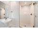 Modern all-white bathroom featuring sleek fixtures, a frameless mirror, and a glass-enclosed shower at 10863 E Hinsdale Cir, Centennial, CO 80112
