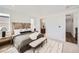 A bedroom with windows and access to a bathroom. The bedroom decor features neutral colors at 10863 E Hinsdale Cir, Centennial, CO 80112
