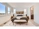 Bright bedroom with large windows, a plush bed, and stylish modern decor at 10863 E Hinsdale Cir, Centennial, CO 80112