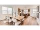 Elegant dining area next to open kitchen, featuring modern table and chairs, and hardwood floors at 10863 E Hinsdale Cir, Centennial, CO 80112
