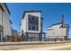 Contemporary three-story house showcasing a stylish exterior with large windows and modern architectural elements at 10863 E Hinsdale Cir, Centennial, CO 80112