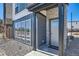Inviting front entrance with a modern gray door, brick accents, and a welcoming 