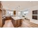 Modern kitchen with a large island, stainless steel appliances, and a cozy seating area with natural light at 10863 E Hinsdale Cir, Centennial, CO 80112