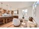 Cozy kitchen nook with seating area, adjacent to the kitchen with an island and modern appliances at 10863 E Hinsdale Cir, Centennial, CO 80112