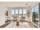 Sun-lit living space with stylish chairs, rug, floor-to-ceiling windows, and access to a patio at 10863 E Hinsdale Cir, Centennial, CO 80112