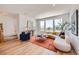 Bright living room with hardwood floors, large windows, stylish furniture, and modern decor at 10863 E Hinsdale Cir, Centennial, CO 80112