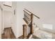 A staircase with wood rails and black iron spindles, and carpet protection at 10863 E Hinsdale Cir, Centennial, CO 80112