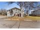 Exterior view of a multi-Gathering home surrounded by mature trees and greenery at 7309 W Hampden Ave # 6103, Lakewood, CO 80227