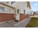 Inviting front entrance with brick accents, a well-maintained lawn, and an attractive white door at 7309 W Hampden Ave # 6103, Lakewood, CO 80227