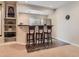 Basement bar area featuring seating for three at 11074 Grayledge Cir, Highlands Ranch, CO 80130