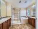 Primary bathroom featuring dual sinks, garden tub and walk-in shower with tiled walls at 11074 Grayledge Cir, Highlands Ranch, CO 80130