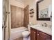 Cozy full bathroom showcasing tiled shower over tub and vanity with framed mirror and wood cabinets at 11074 Grayledge Cir, Highlands Ranch, CO 80130