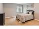 Neutral bedroom with a queen bed, soft carpet, and gray walls at 11074 Grayledge Cir, Highlands Ranch, CO 80130