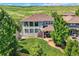 Beautiful home with mature landscaping, a covered patio and a well-manicured lawn at 11074 Grayledge Cir, Highlands Ranch, CO 80130