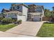 Stylish two-story home with a wide driveway and well-maintained lawn and landscaping at 11074 Grayledge Cir, Highlands Ranch, CO 80130