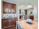 Spacious kitchen with wooden cabinets, granite countertops and an island view to the breakfast nook at 11074 Grayledge Cir, Highlands Ranch, CO 80130