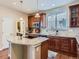 Kitchen featuring granite countertops, tiled backsplash, and wood cabinetry with island and stainless appliances at 11074 Grayledge Cir, Highlands Ranch, CO 80130