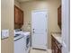 Functional laundry room with modern washer/dryer, cabinetry, and a sink for added convenience at 11074 Grayledge Cir, Highlands Ranch, CO 80130