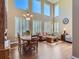 Open concept living room featuring tall windows, hardwood floors, and elegant dining area at 11074 Grayledge Cir, Highlands Ranch, CO 80130