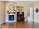 Beautiful living room showcasing brick fireplace, and hardwood floors with nearby staircase at 11074 Grayledge Cir, Highlands Ranch, CO 80130