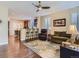 Open floorplan view of the living room, kitchen bar, and stylish furnishings with hardwood floors at 11074 Grayledge Cir, Highlands Ranch, CO 80130