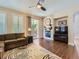 Comfortable living room with hardwood floors, brick fireplace, ceiling fan and sliding glass door at 11074 Grayledge Cir, Highlands Ranch, CO 80130