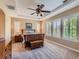 Bright main bedroom with trey ceiling, ceiling fan, shutters, and warm neutral colored walls at 11074 Grayledge Cir, Highlands Ranch, CO 80130