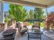 Inviting covered patio featuring comfortable seating and a cozy fire pit with lush backyard views at 11074 Grayledge Cir, Highlands Ranch, CO 80130