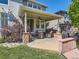Charming covered patio with stone pillars, outdoor furniture, and a built-in grill, perfect for entertaining at 11074 Grayledge Cir, Highlands Ranch, CO 80130